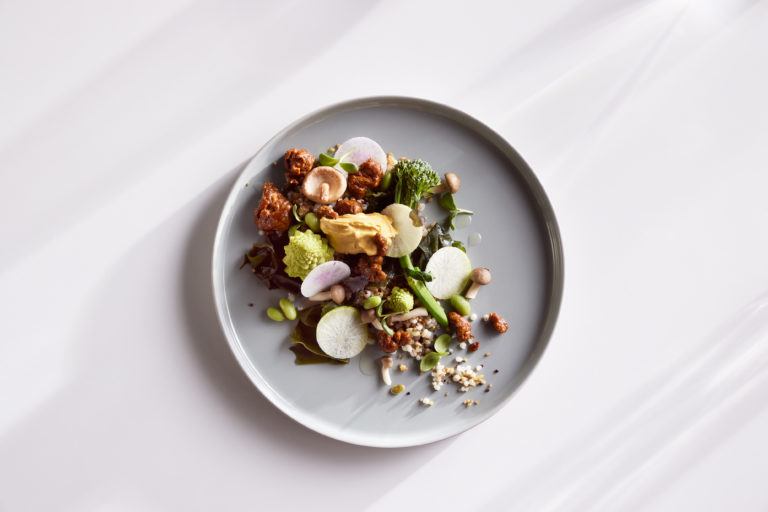A white plate with different hydrogen powered foods on a white background